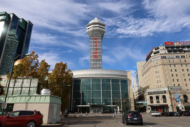 Casino Niagara on Falls Avenue: a round glass entrance building under a tall tower lettered CASINO, beside a hotel.